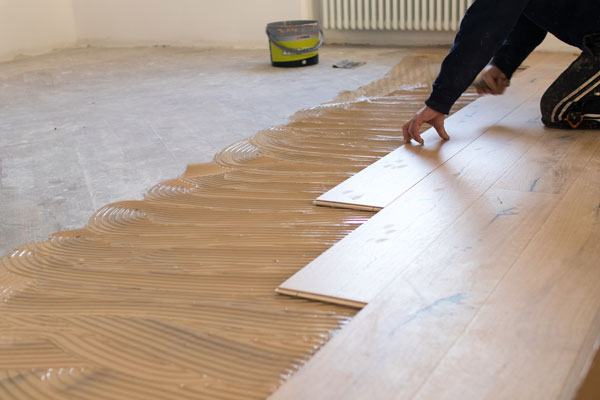 Renovation Of An Apartment, Skilled Worker Uses A Plastic Hammer
