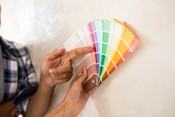 Couple Choosing Color For Painting There New Home